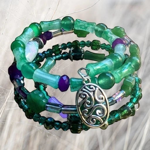 Heartfelt Creations emerald forest coil bracelet stack with green and purple bamboo-shaped beads and silver charm