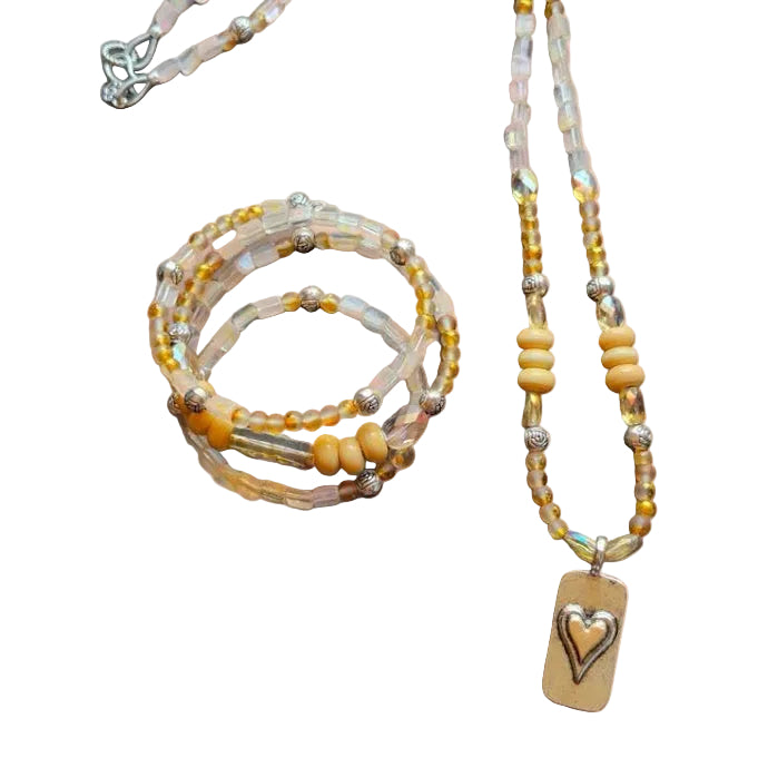 Beaded necklace with a heart pendant on a beige background