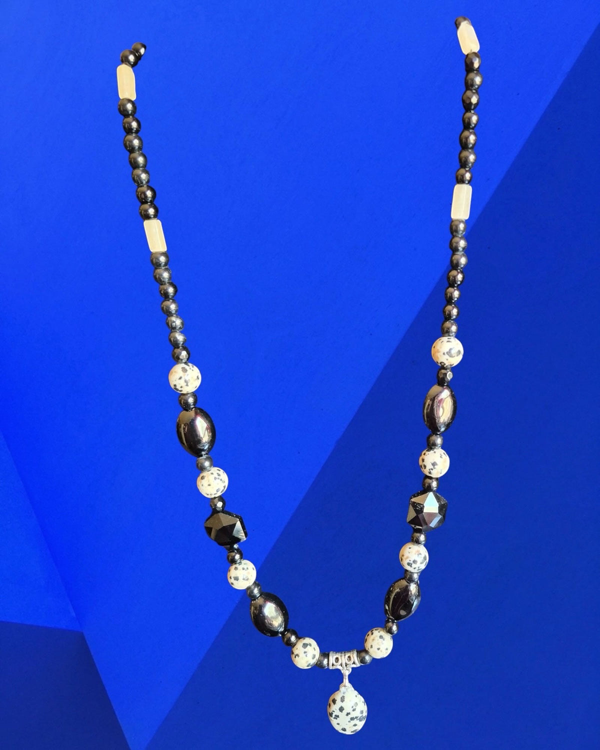 Heartfelt Creations beaded necklace featuring black, white, and Dalmatian Jasper stone beads with a central pendant.