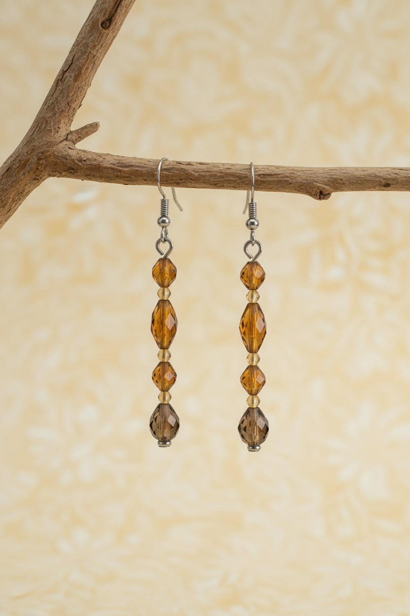 A handmade, beaded necklace and matching drop earrings.  The jewelry features dark amber-brown faceted beads, small metallic gold beads, and a polished light yellow-green stone pendant.  BOHEMIAN YET VERY CLASSY