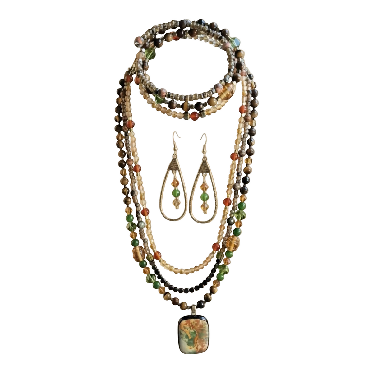 A multi-strand beaded necklace set with matching teardrop earrings, featuring natural stones in green, brown, orange, and cream, with a square pendant showcasing a colorful floral design.