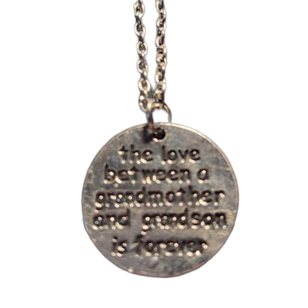 A silver-stainless steel round pendant necklace with engraved text reading 'the love between a grandmother and grandson is forever.'