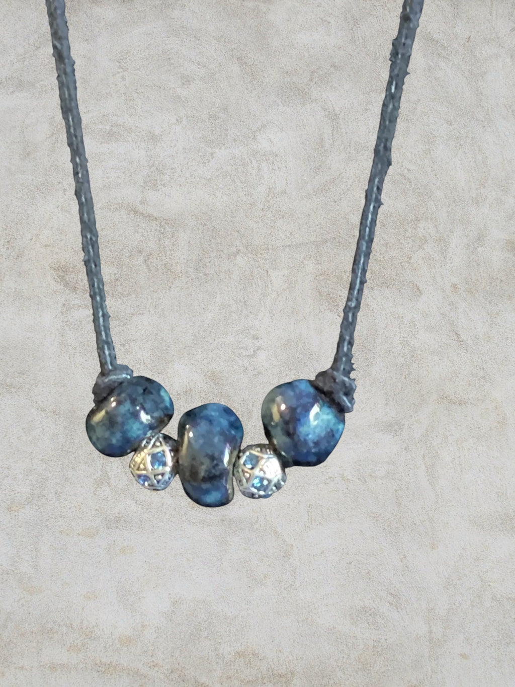 Heartfelt Creations Ocean Gemstone Beaded Necklace with irregular deep blue beads and silver spacers with blue gems.