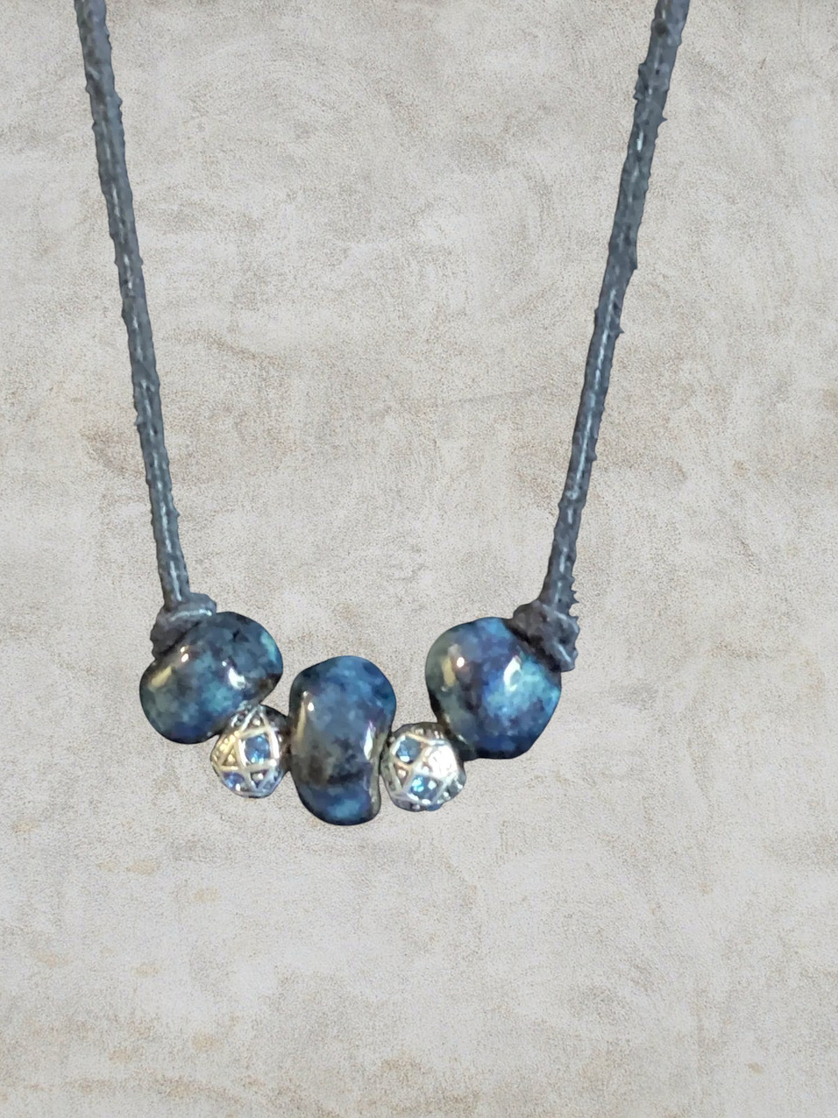 Heartfelt Creations Ocean Gemstone Beaded Necklace with irregular deep blue beads and silver spacers with blue gems.