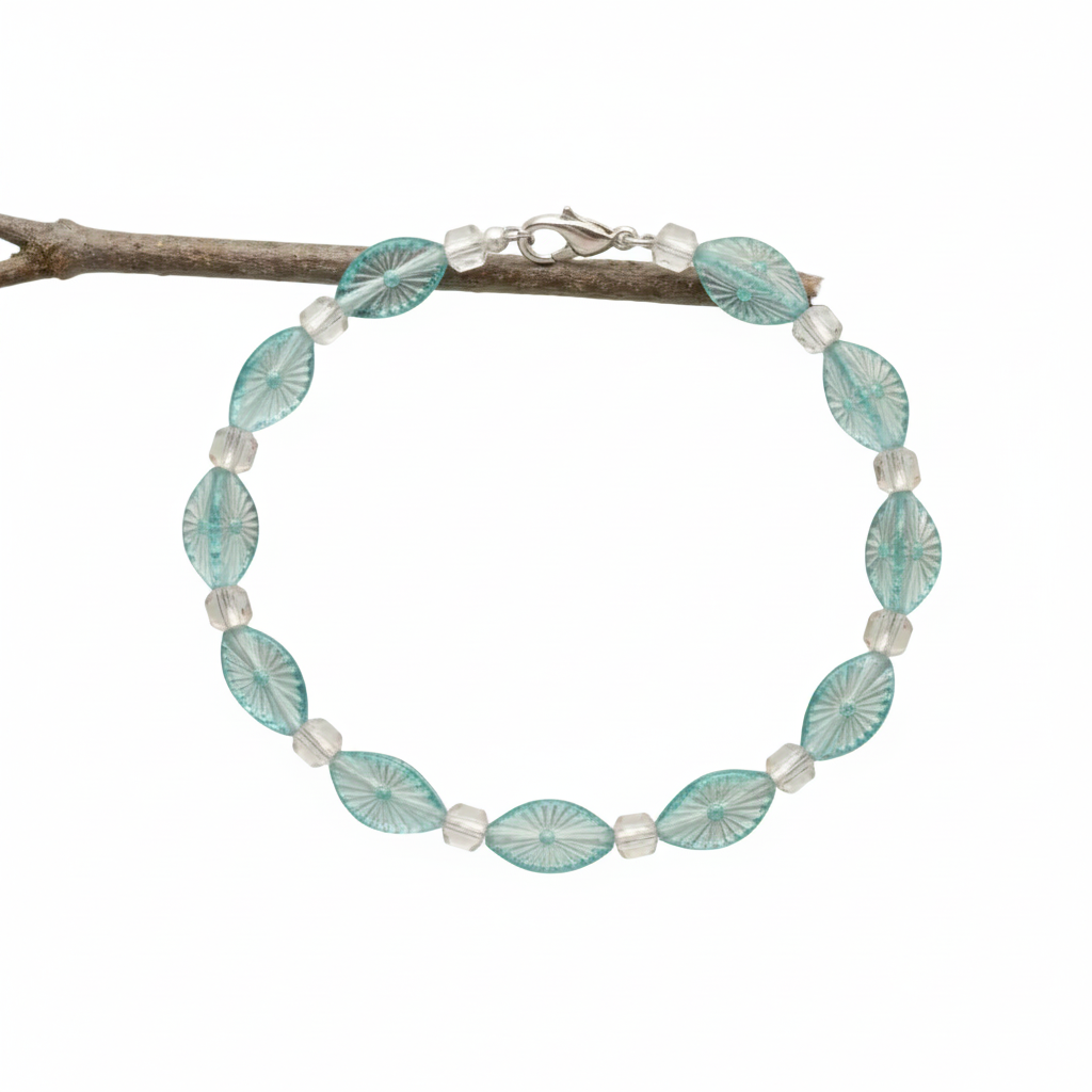 a delicate bracelet featuring alternating oval-shaped, light blue glass beads with a textured sunburst pattern and smaller, clear, faceted glass beads, secured with a silver-toned clasp.