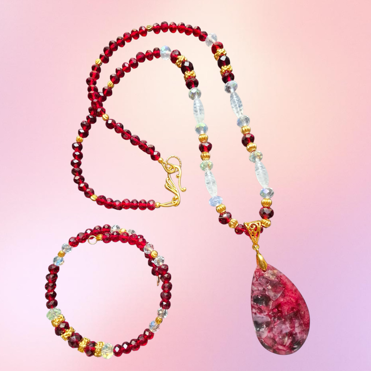 Heartfelt Creations jewelry set with a teardrop gemstone pendant, crimson garnet beads, and iridescent crystal accents.
