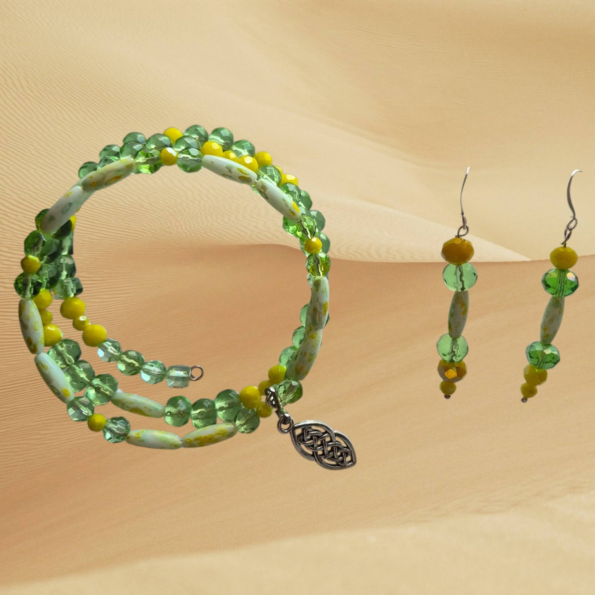 Heartfelt Creations multi-strand beaded bracelet with green glass, yellow accents, and a silver Celtic knot charm.