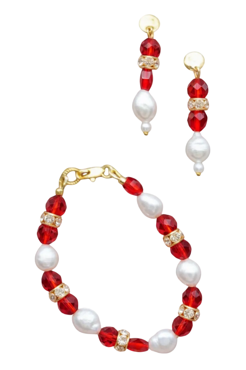 A jewelry set featuring a bracelet and matching drop earrings, decorated with faceted red beads, white pearl-like beads, and gold-toned spacer rings with clear rhinestones, shown on a plain white background.