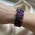 Beaded bracelet with red and black beads on a beige background