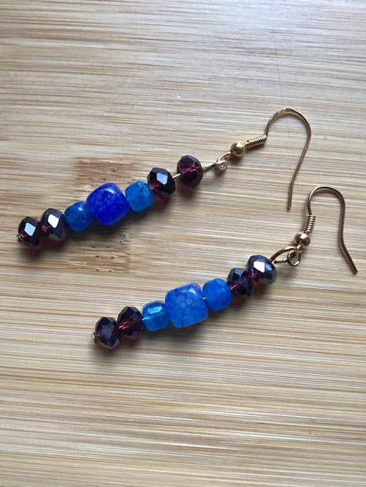 Heartfelt Creations' most off-beat 3-piece handmade and designed jewelry set.  The bohemian beaded necklace, earring and bracelet set with deep red, brown, and blue stones. Necklace features a stacked stone pendant.