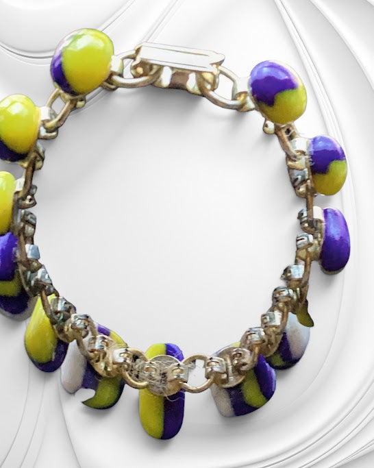 Bracelet with yellow and purple beads on a white background