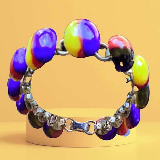 Colorful beaded bracelet with silver chain on a yellow background