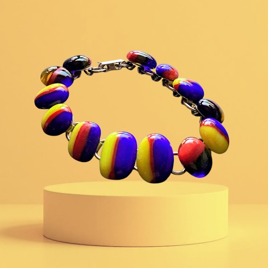 Colorful beaded bracelet with handmade ceramic beads  on a yellow background