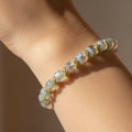 Beaded bracelet with gold accents on a dark background