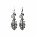 A pair of silver-toned dangle earrings with intricate filigree leaf-shaped pendants and faceted iridescent beads at the top, shown on a plain white background.