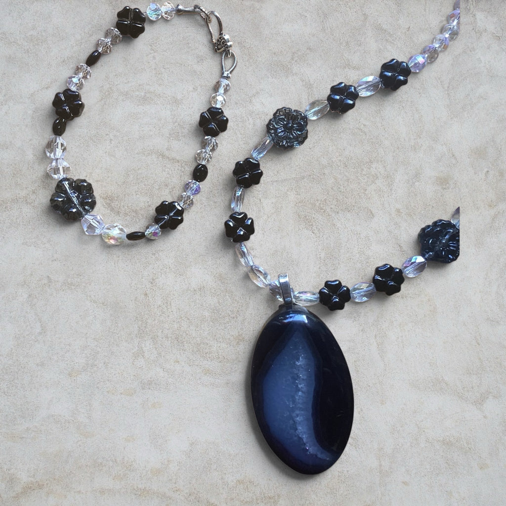 Heartfelt Creations handcrafted necklace and bracelet set with a dark agate pendant, black floral beads, and crystals.