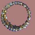 Heartfelt Creations multi-strand coil bracelet with amber, clear faceted beads, and silver accents. Adjustable wrap design.