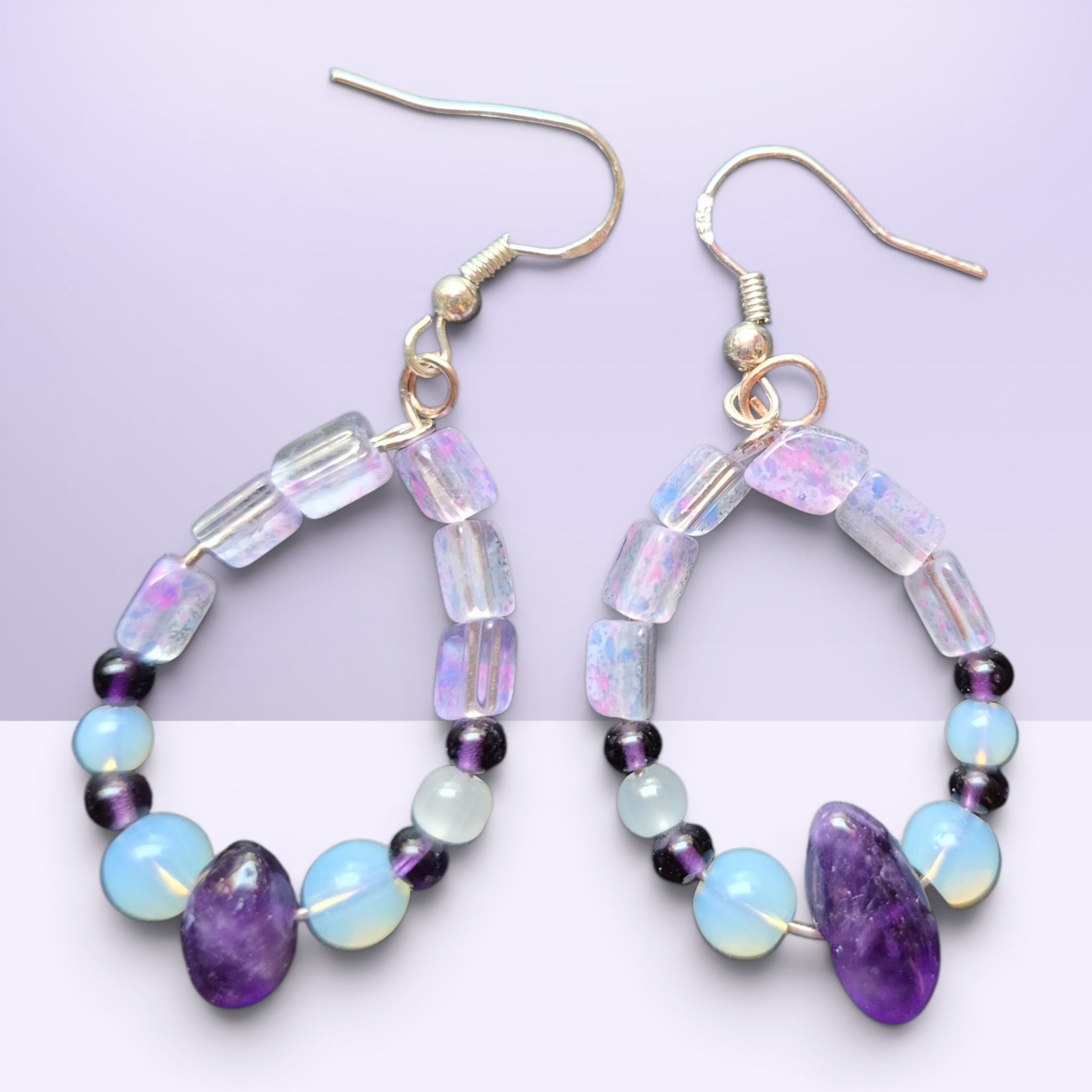 Heartfelt Creations bohemian drop earrings featuring amethyst, iridescent opal-style beads, and pearls on silver hooks.