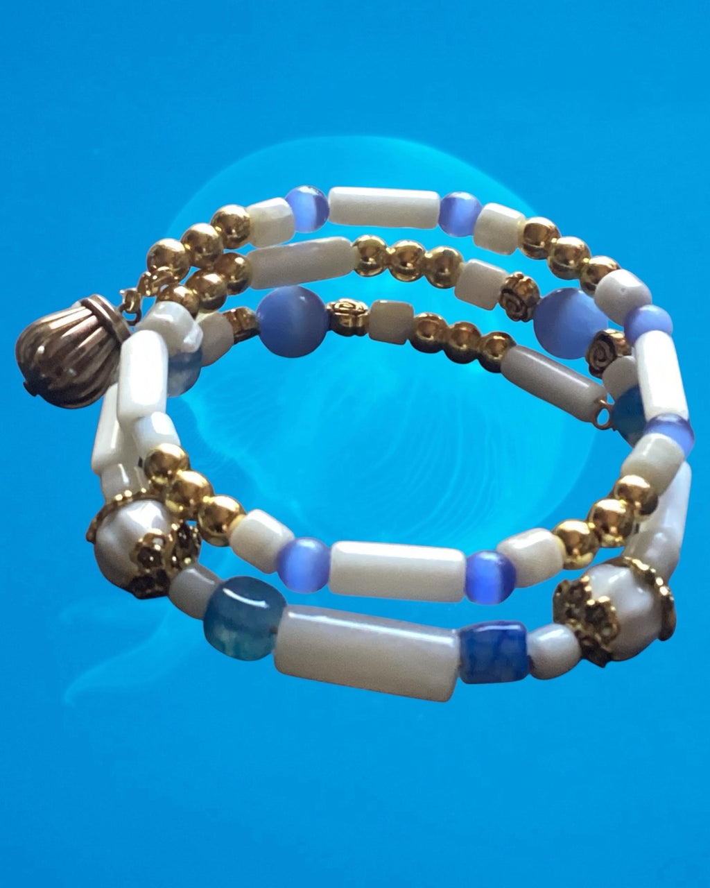 Heartfelt Creations beaded bracelet with white cylindrical beads, blue accents, and gold-tone metal spacers