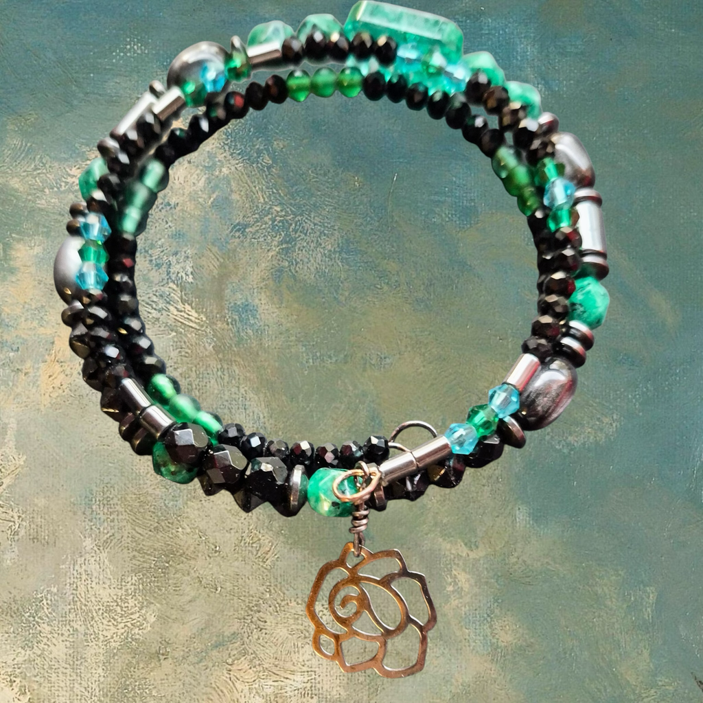 Heartfelt Creations artisan bracelet with black crystals, green beads, hematite, and rose charm.