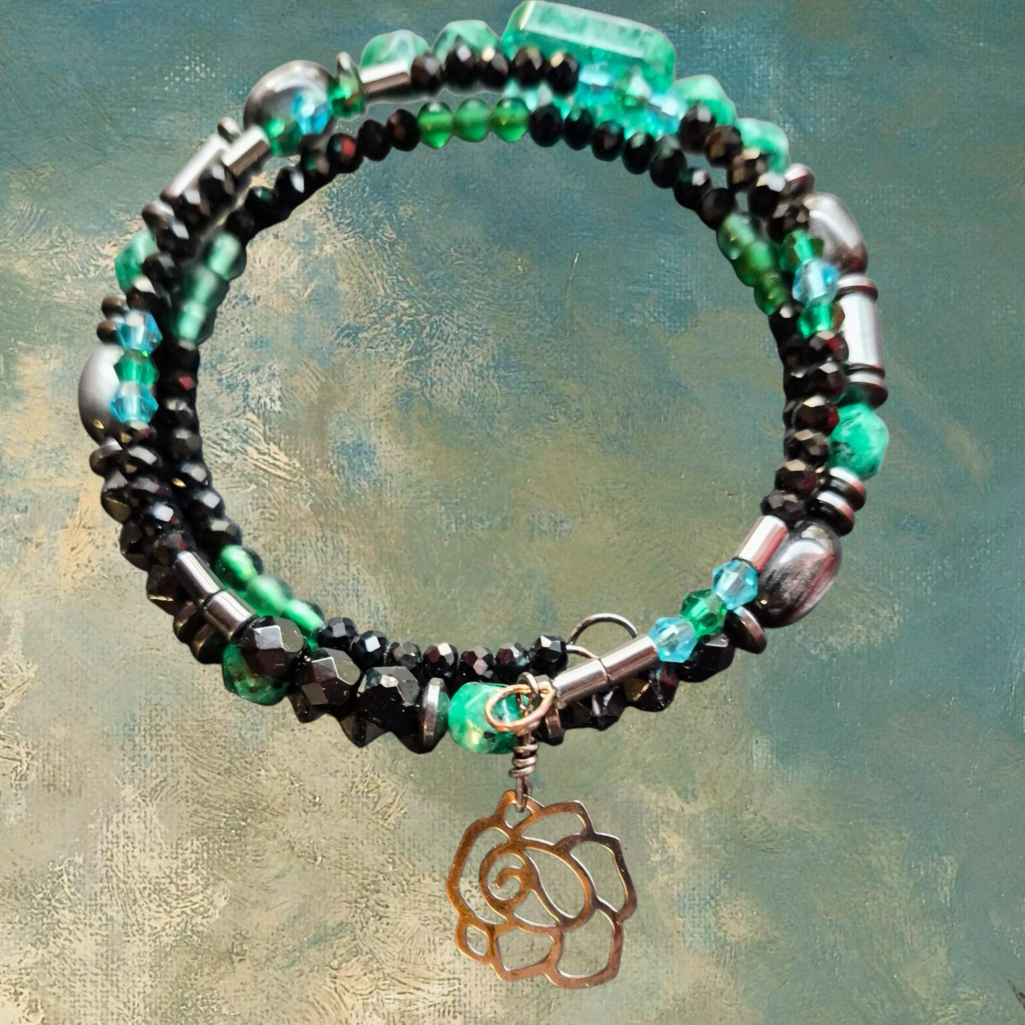 Heartfelt Creations artisan bracelet with black crystals, green beads, hematite, and rose charm.