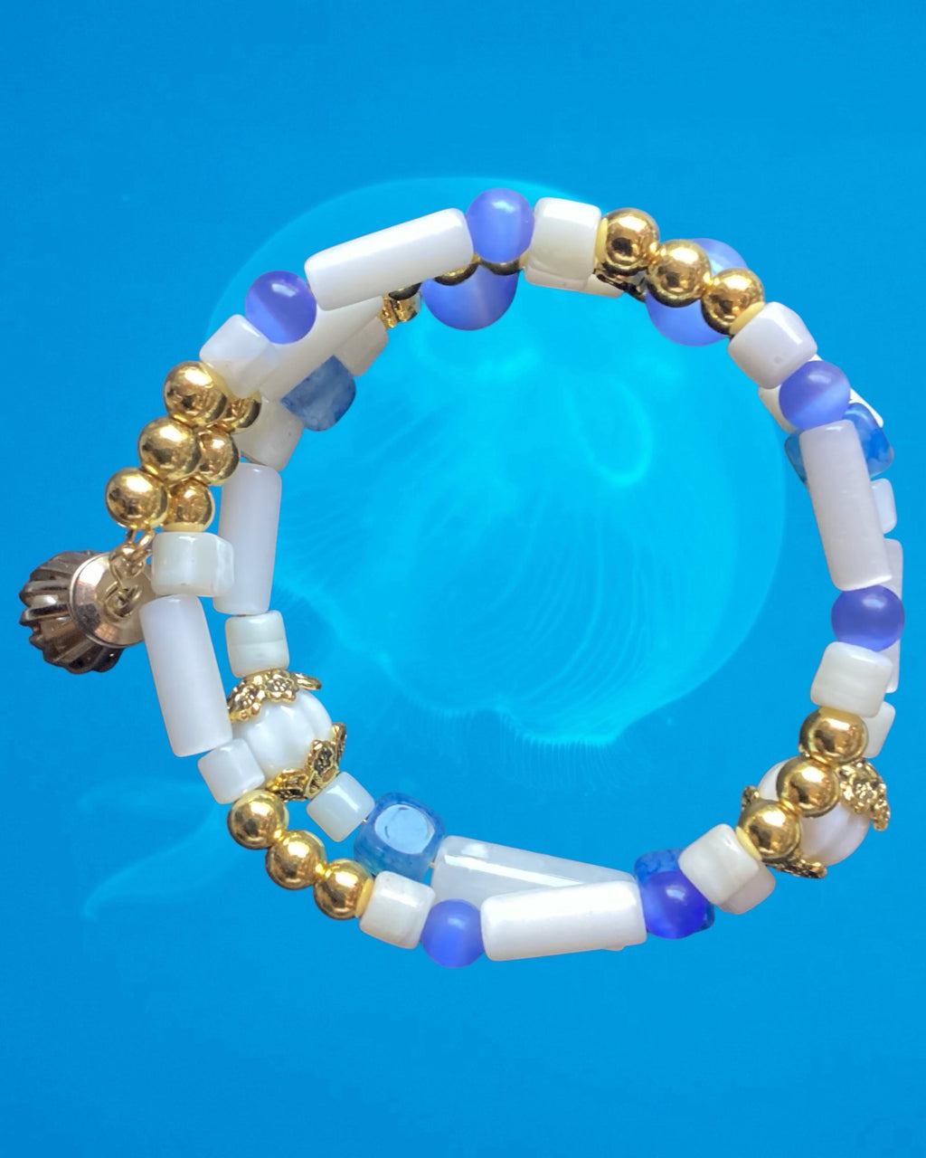 Heartfelt Creations beaded bracelet with white cylindrical beads, blue accents, and gold-tone metal spacers
