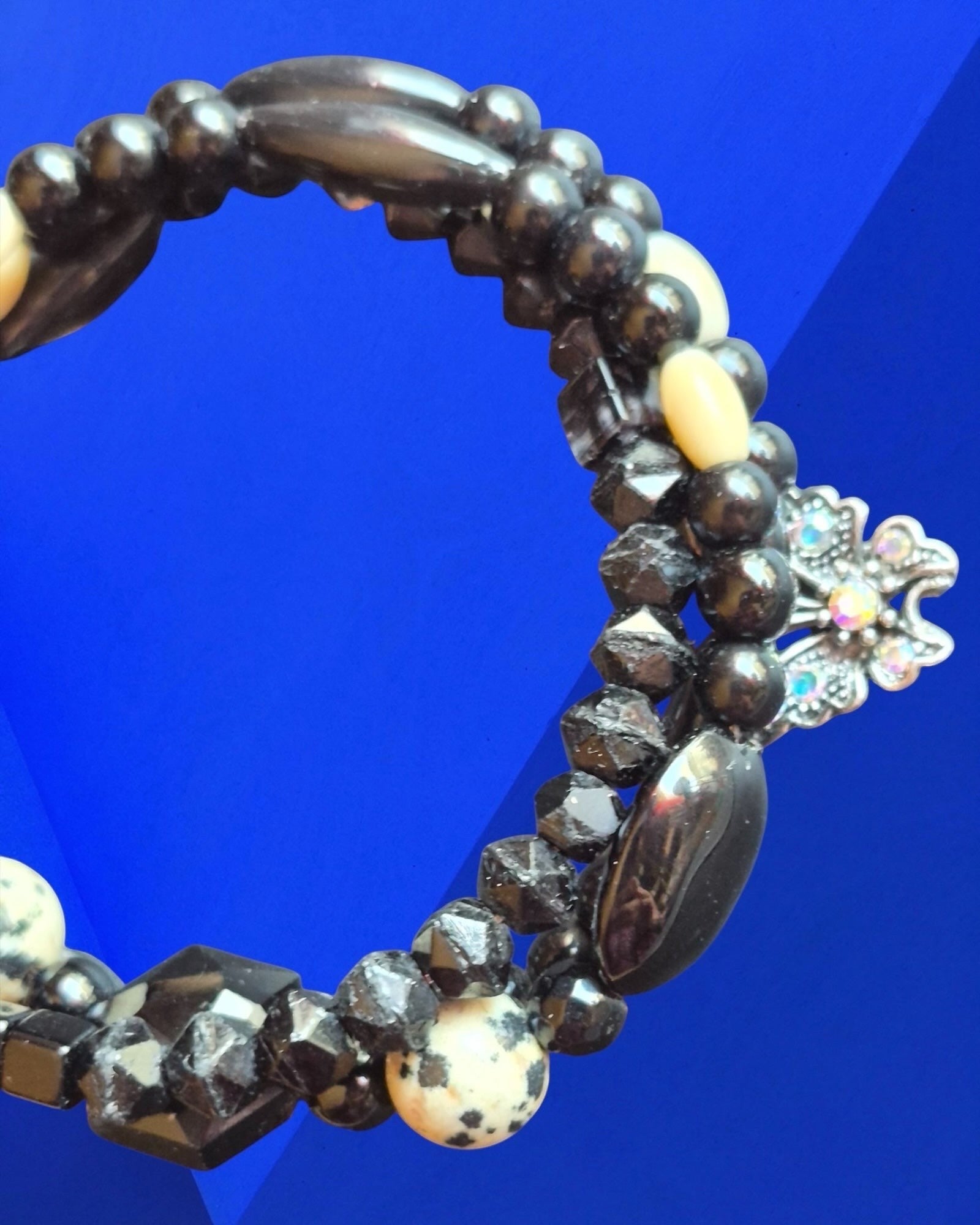Heartfelt Creations black and white beaded bracelet featuring faceted stones and a shimmering butterfly charm