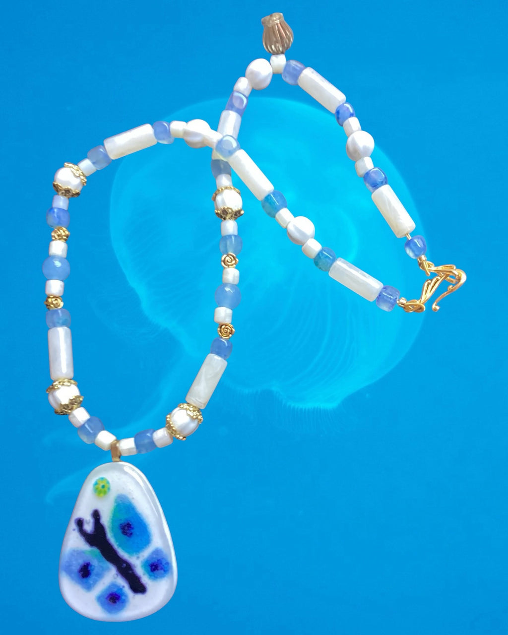 Heartfelt Creations handcrafted beaded necklace with a blue and white butterfly pendant and gold-tone spacers