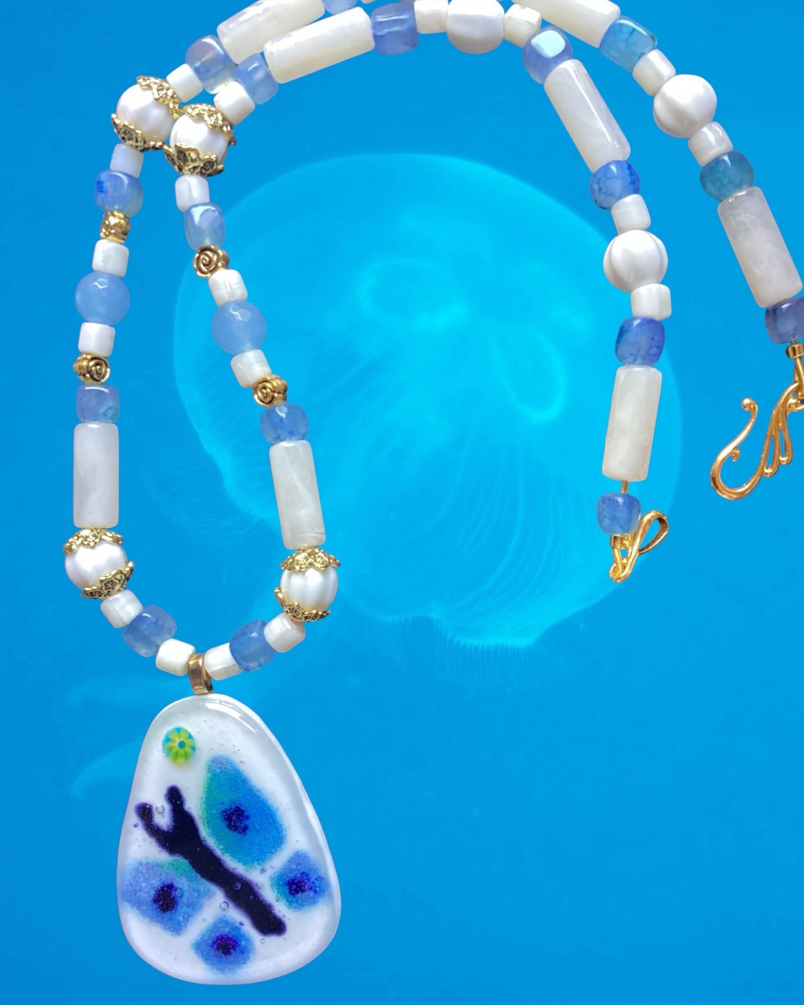 Heartfelt Creations handcrafted beaded necklace with a blue and green butterfly pendant and gold-tone accents