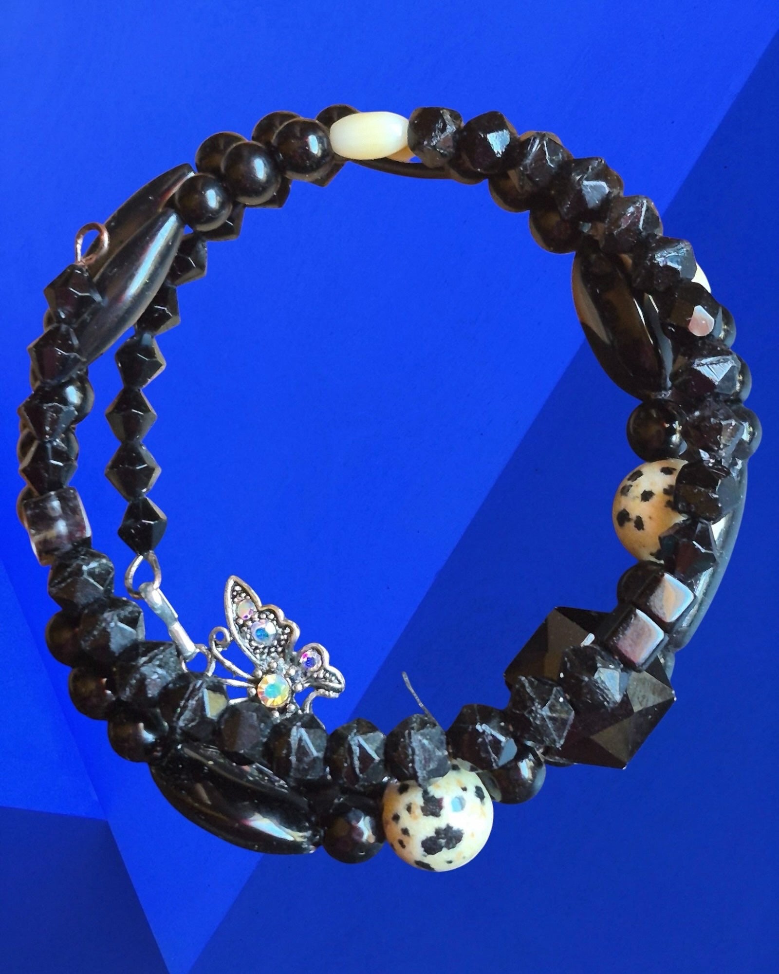 Heartfelt Creations black and white beaded wrap bracelet featuring Dalmatian Jasper stones and a shimmering butterfly charm.