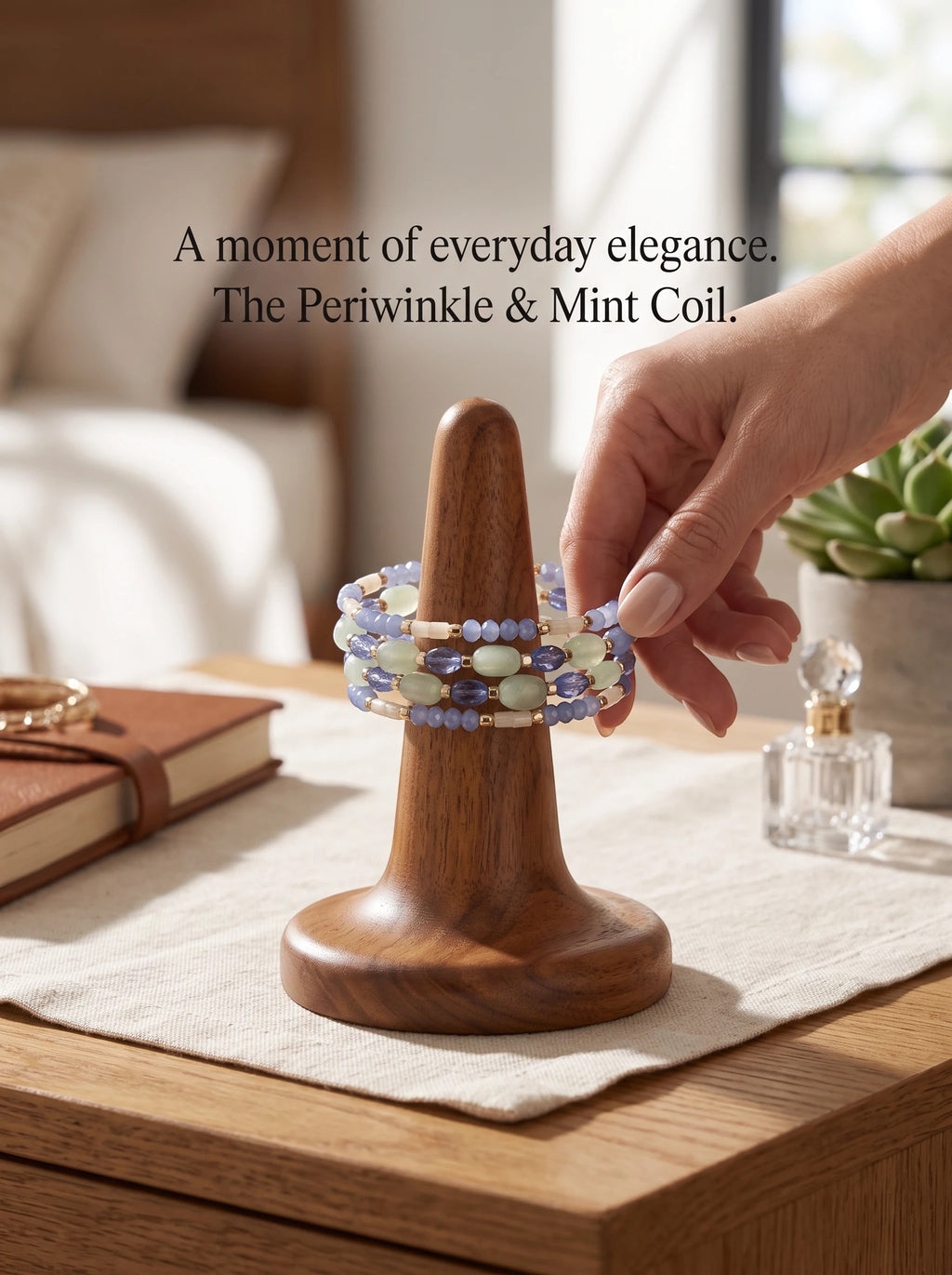 Heartfelt Creations periwinkle and mint multi-strand beaded coil bracelet on a wooden display stand