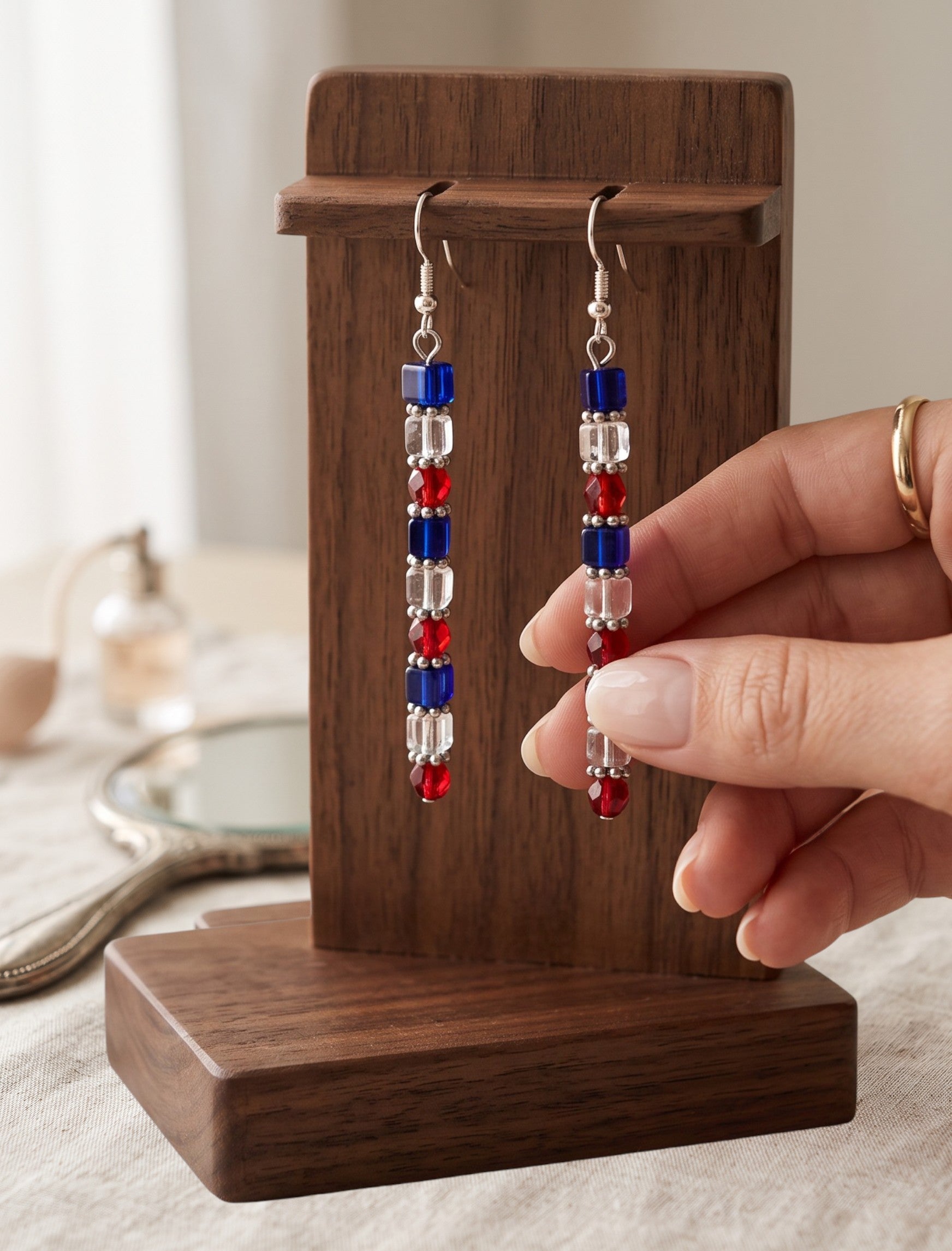 Heartfelt Creations handcrafted beaded dangle earrings with red, white, and blue geometric beads on silver hooks.