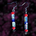 Heartfelt Creations handcrafted dangle earrings featuring red, blue, and iridescent clear beads on silver hooks.