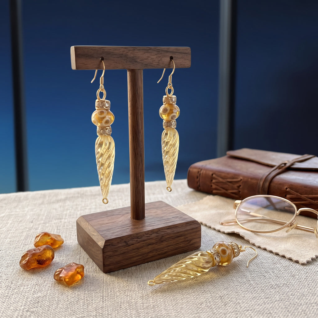 Heartfelt Creations elegant gold-tone drop earrings with textured yellow glass beads on a wooden display stand.