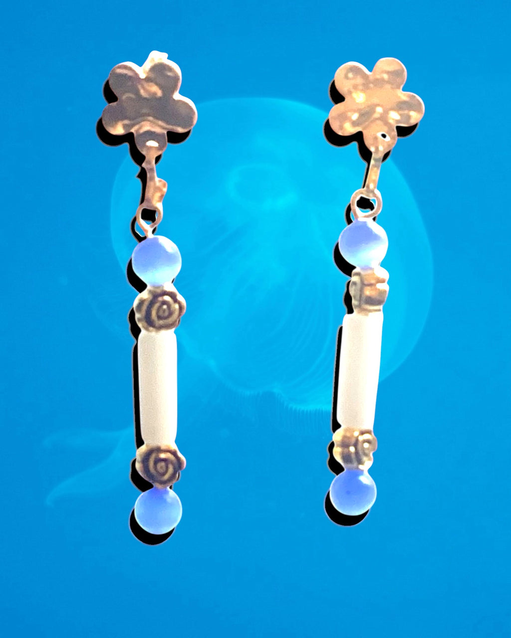 Heartfelt Creations drop earrings featuring white cylindrical beads, blue accents, and gold-tone flower motifs.