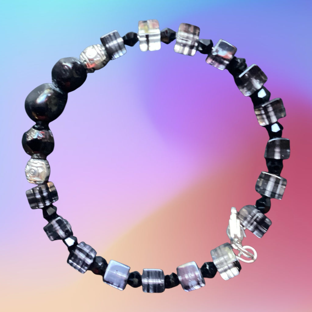 Heartfelt Creations handcrafted beaded bracelet featuring square translucent beads, black spheres, and silver accents.