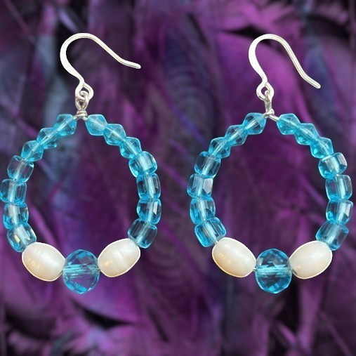 Heartfelt Creations handcrafted hoop earrings featuring faceted turquoise blue glass beads and creamy white faux pearls.