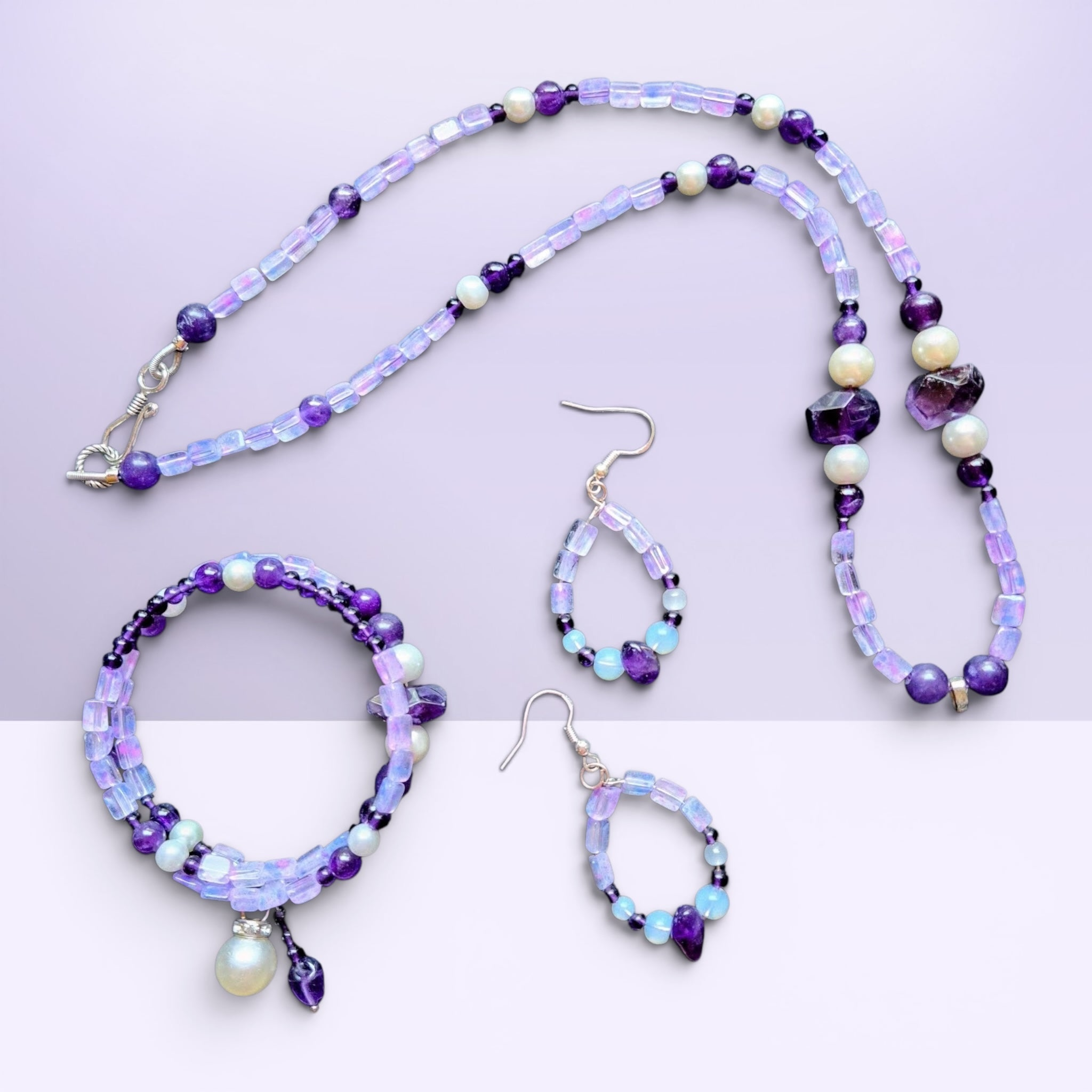 Heartfelt Creations bohemian jewelry set featuring amethyst, iridescent opal-style beads, and pearls in necklace, bracelet, and drop earrings.