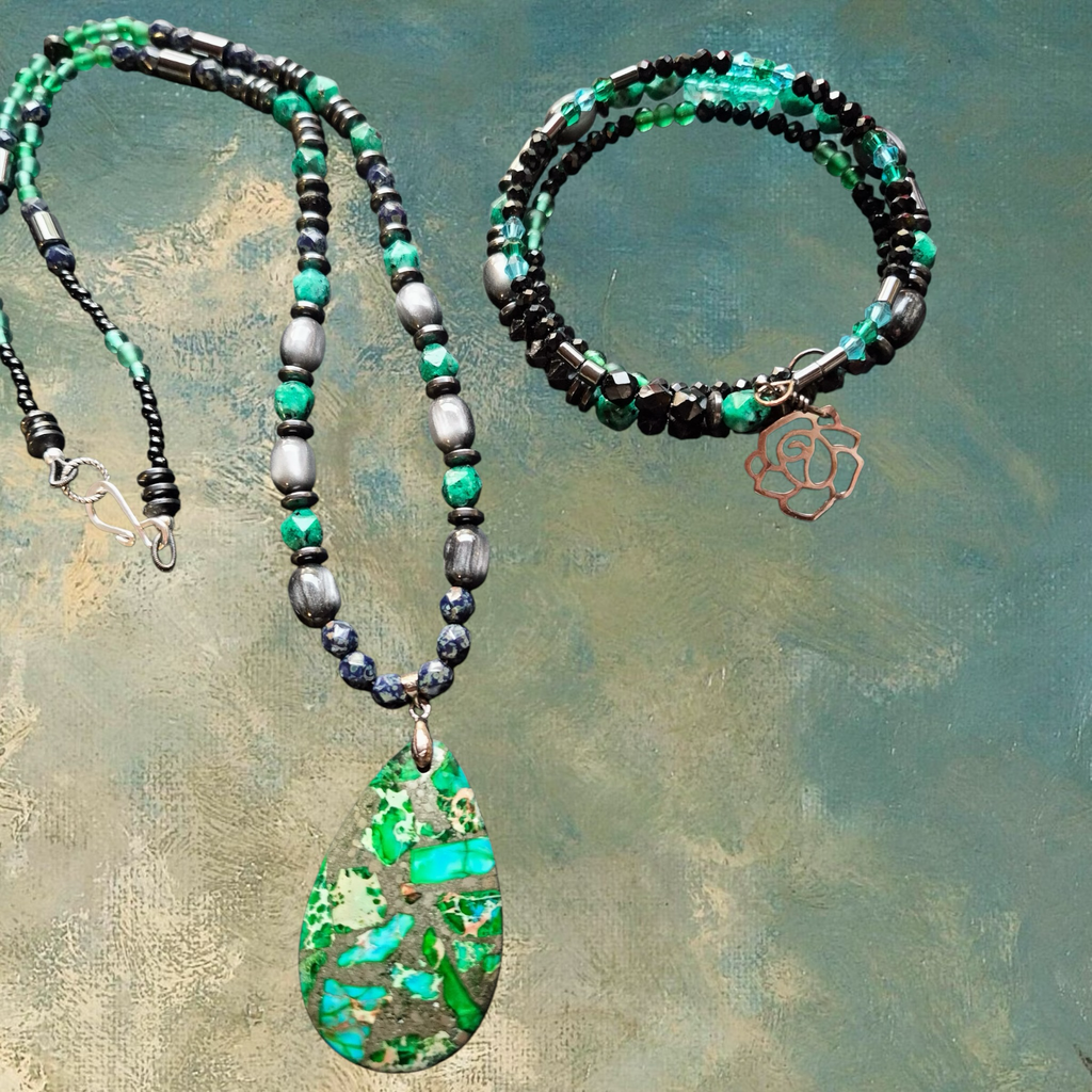 Heartfelt Creations artisan beaded necklace and bracelet set with pendant. Green, blue, and hematite beads with a teardrop pendant and rose charm.