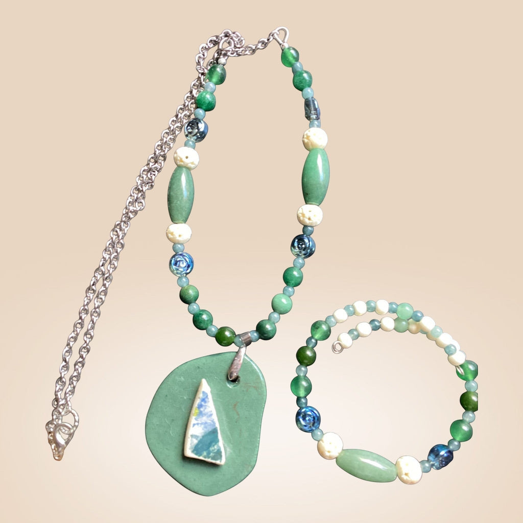 Heartfelt Creations artisan beaded necklace and wrap bracelet set in green, blue, and off-white with organic pendant.