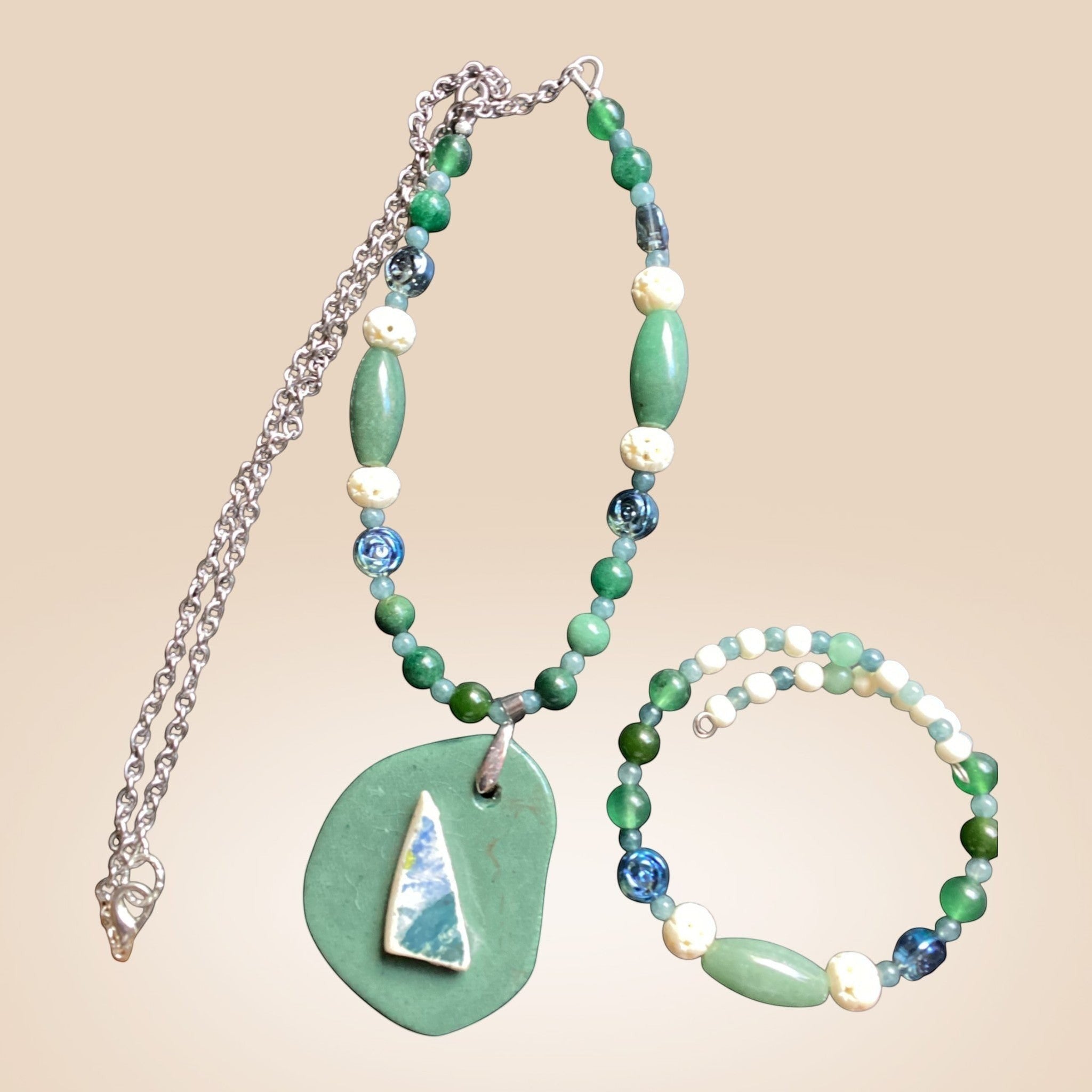Heartfelt Creations artisan beaded necklace and wrap bracelet set in green, blue, and off-white with organic pendant.