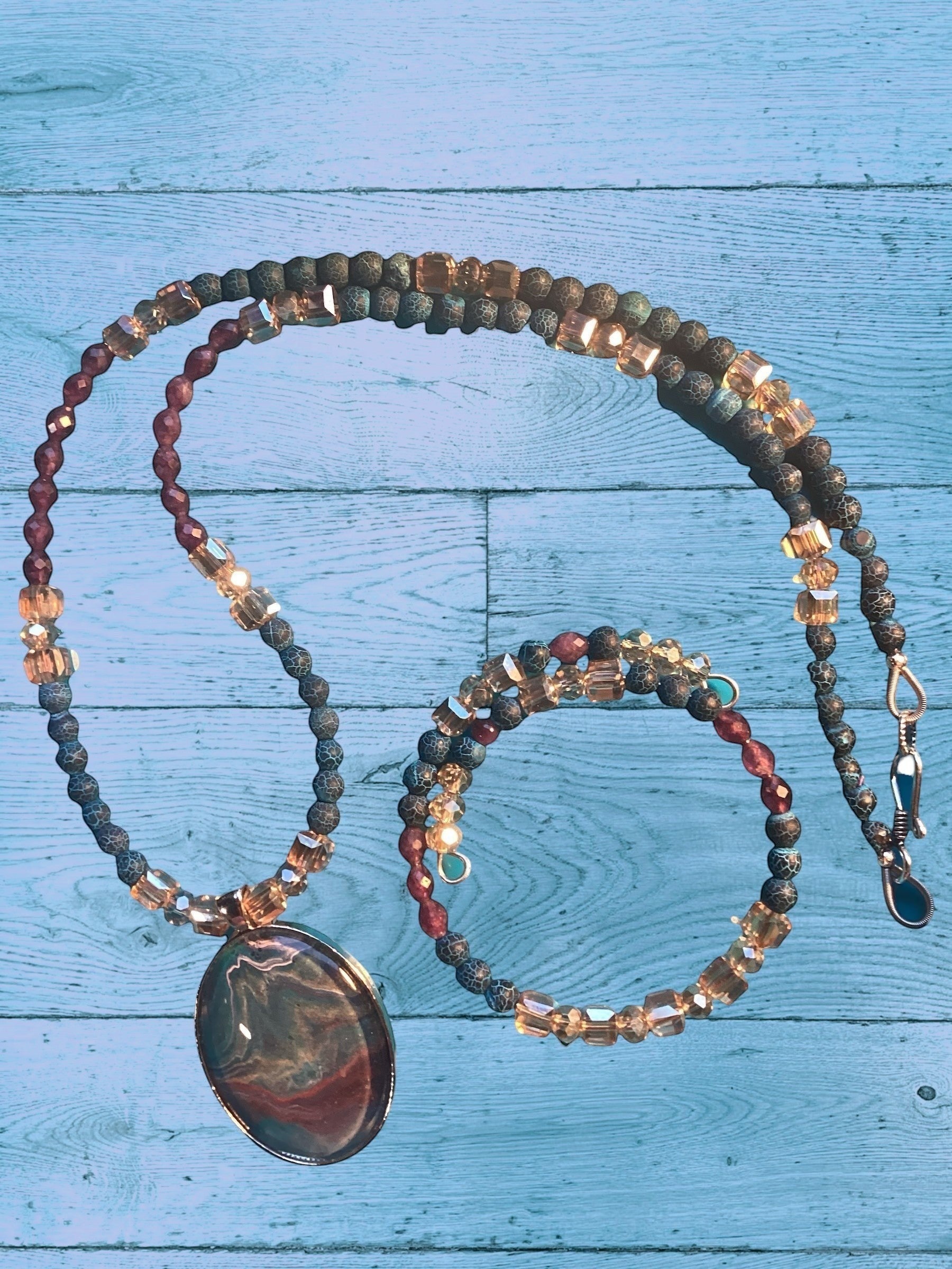 Heartfelt Creations artisan jewelry set featuring a marbled oval pendant, blue-grey agate beads, and amber crystal cubes.