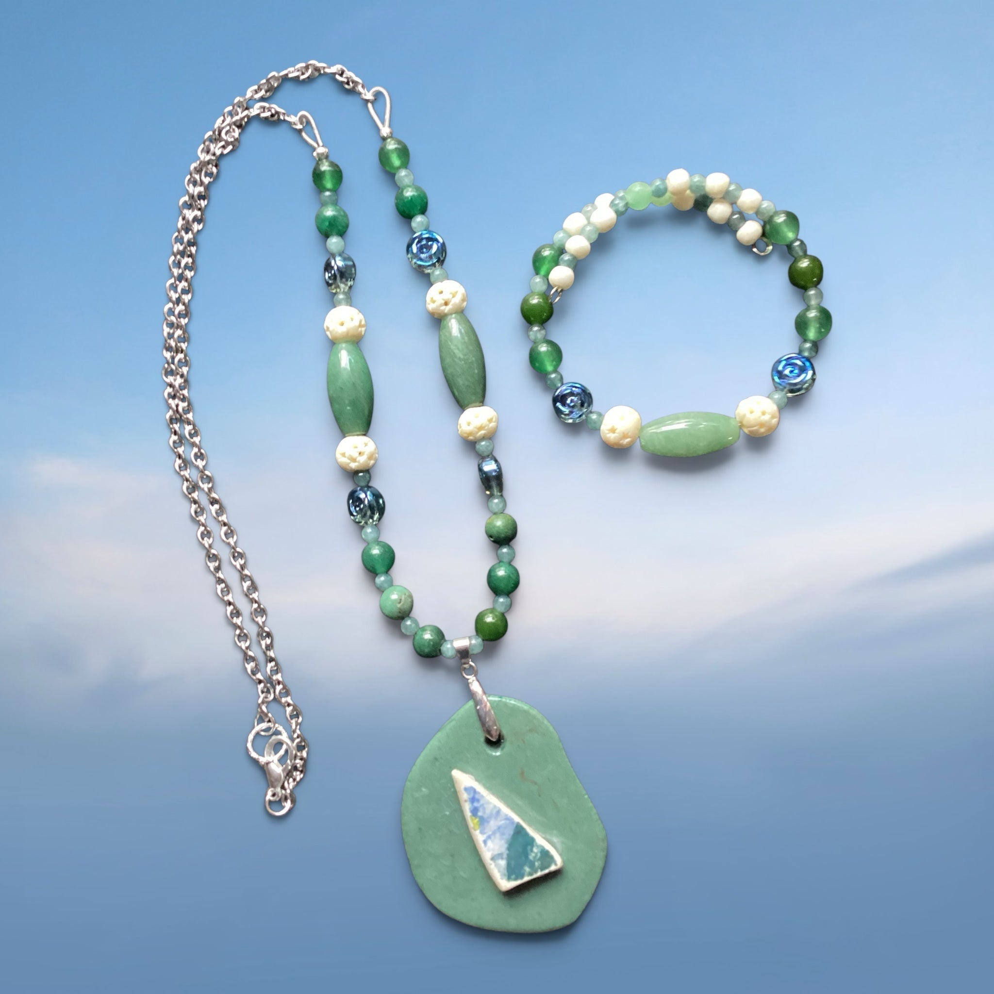 Heartfelt Creations handcrafted necklace and bracelet set with green beads, cream accents, and a geometric pendant.
