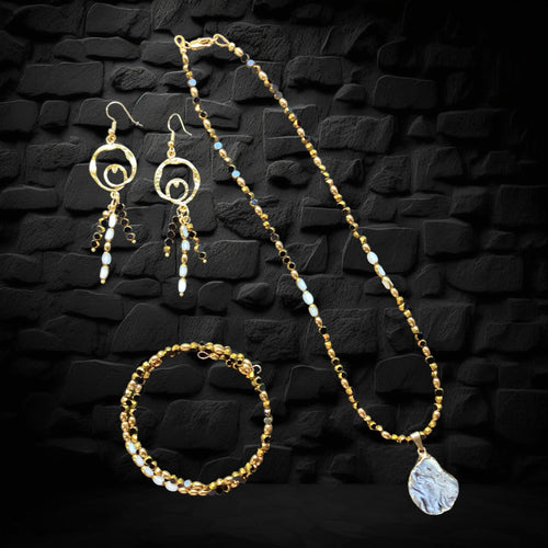 Heartfelt Creations three-piece jewelry set with gold-toned beads, black accents, white stones, and organic pendant.