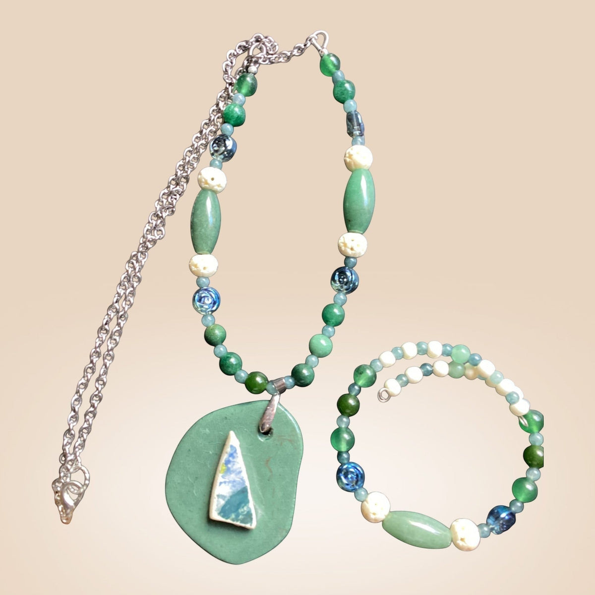Heartfelt Creations artisan necklace featuring green stone beads, glass accents, and an organic ceramic pendant.
DEFINATELY ONE OF A KIND!!!