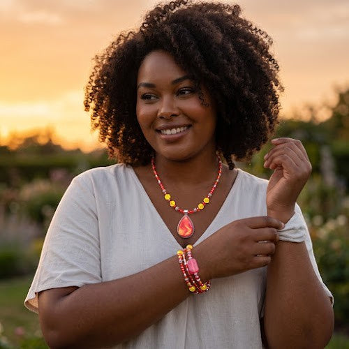 Heartfelt Creations handcrafted necklace and bracelet set with red and yellow beads and a teardrop pendant on a woman
