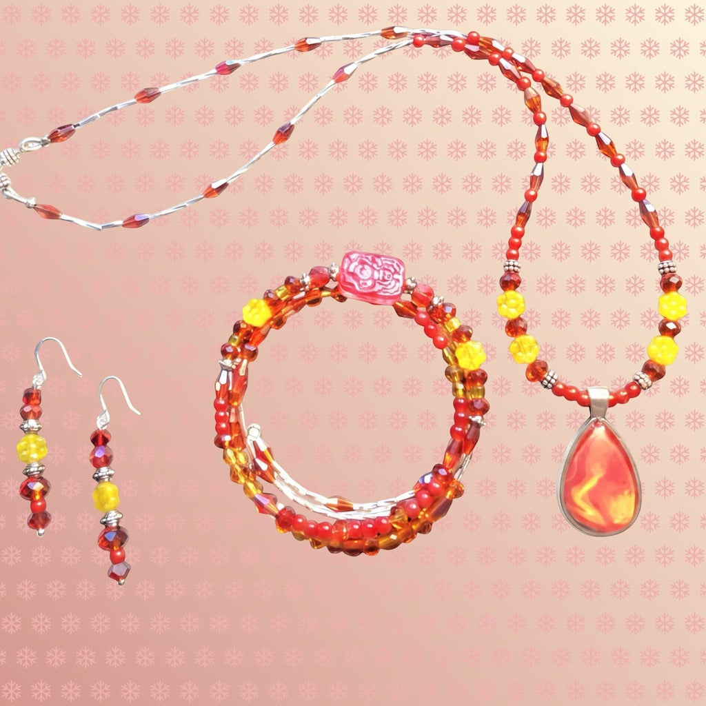 Heartfelt Creations handcrafted jewelry set featuring a red and yellow teardrop pendant necklace, wrap bracelet, and earrings.