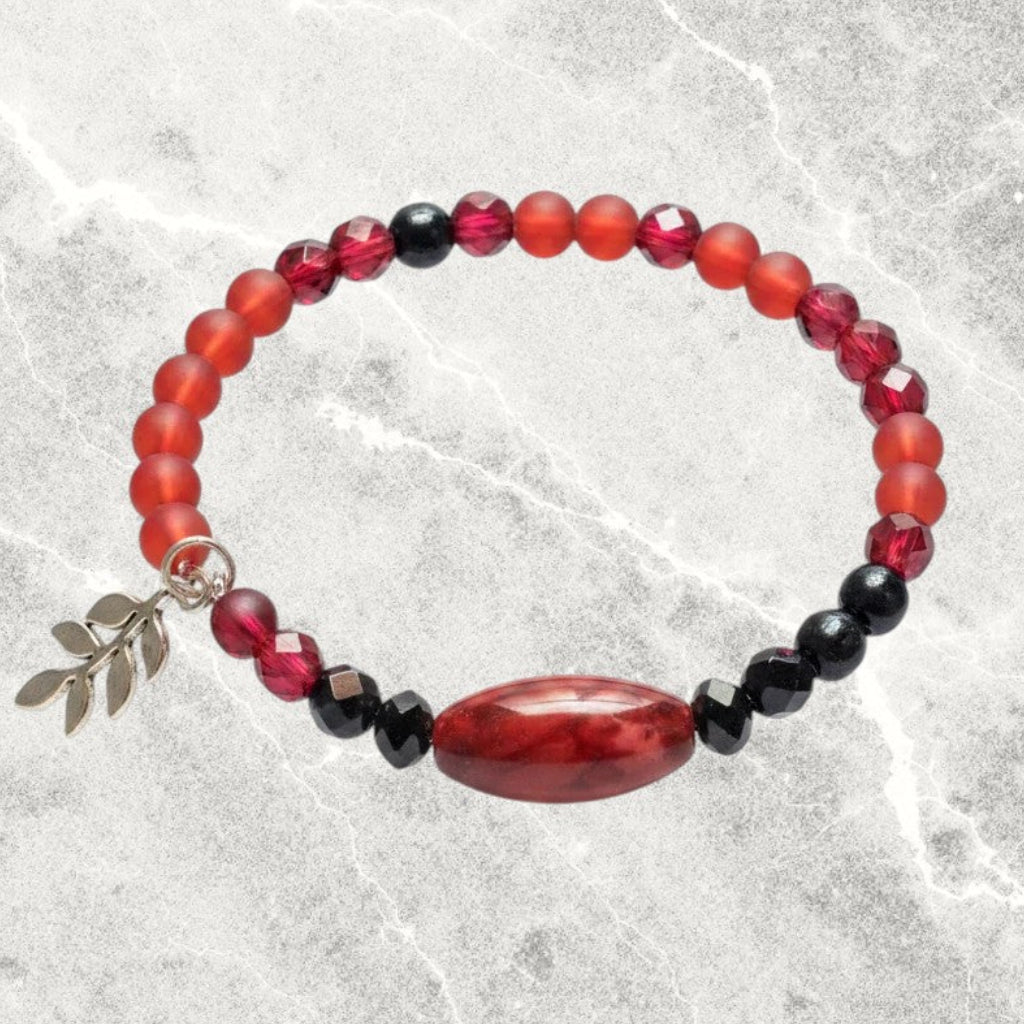 Heartfelt Creations beaded wire wrap bracelet featuring crimson and black beads with a gold-toned leaf charm