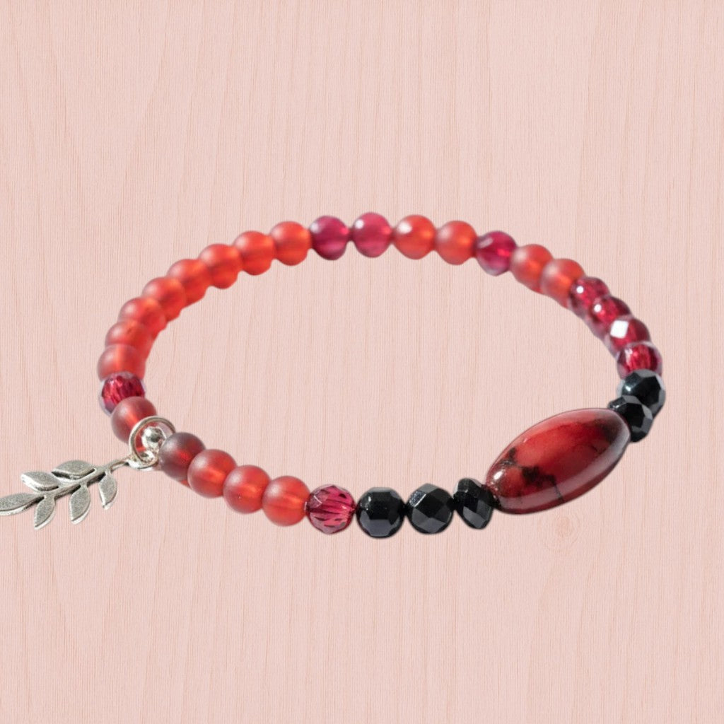Heartfelt Creations beaded wire Wrap bracelet featuring crimson and black beads with a gold-toned leaf charm