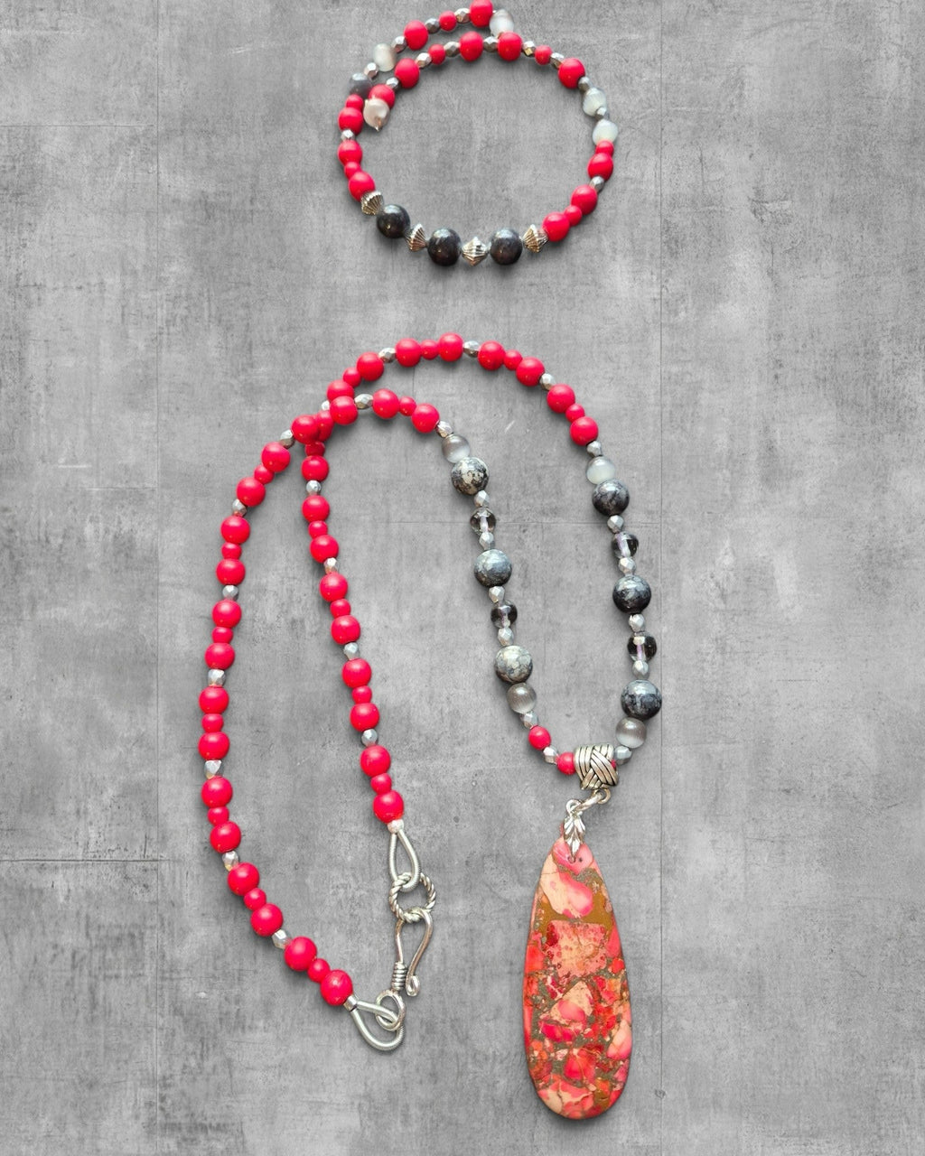Heartfelt Creations beaded jewelry set with red matte beads, grey stone accents, and a marbled agate teardrop pendant.